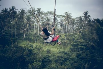 Girl Swinging Scary Heights for travelling