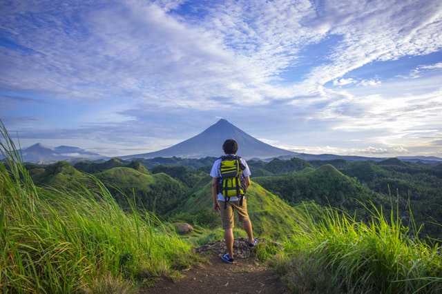 Traveler standing infront of peak